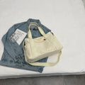 Women's shoulder tote bag in solid colour with sandwich pocket and internal mobile phone compartment for leisure travel