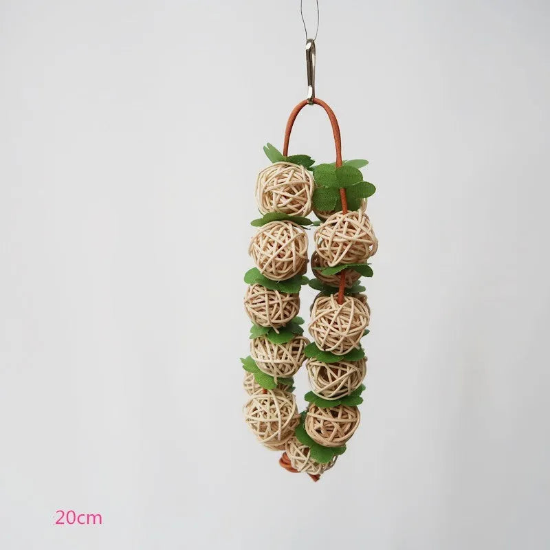 Natural rattan parrot chew toy, 20 cm long, 35 g, with hanger, shown in pink or primary colour for birdcages
