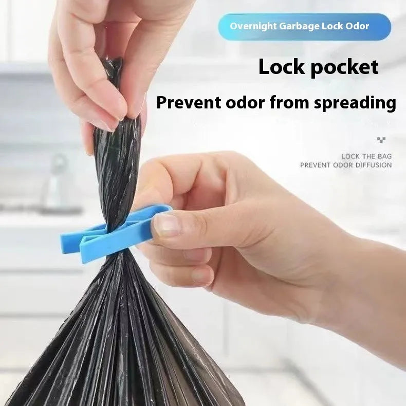 Black plastic non-slip clip for holding bin bags on the side of a trash can.