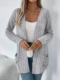 Solid colour long sleeve cardigan knitwear with two pockets, shown in granny grey.