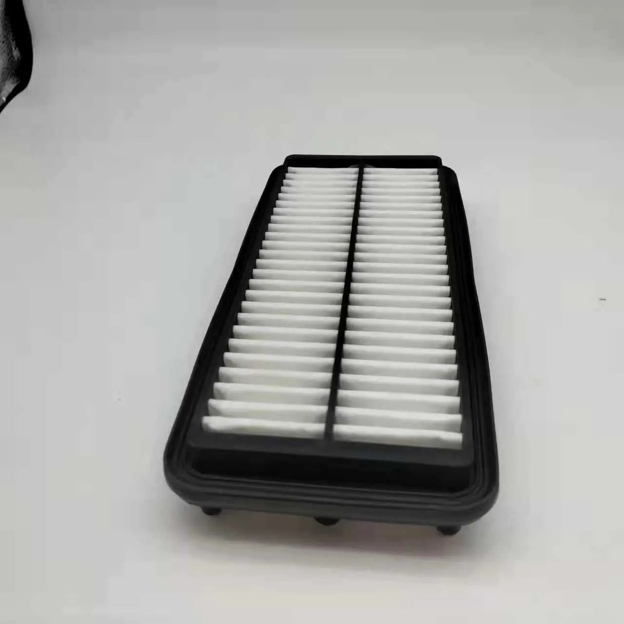 Black car air filter with dimensions 256mm by 113mm by 40mm for Modern vehicles