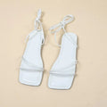 Women's flat sandals with ankle ring bandage cloth design in black colour showing square toe and rubber soles