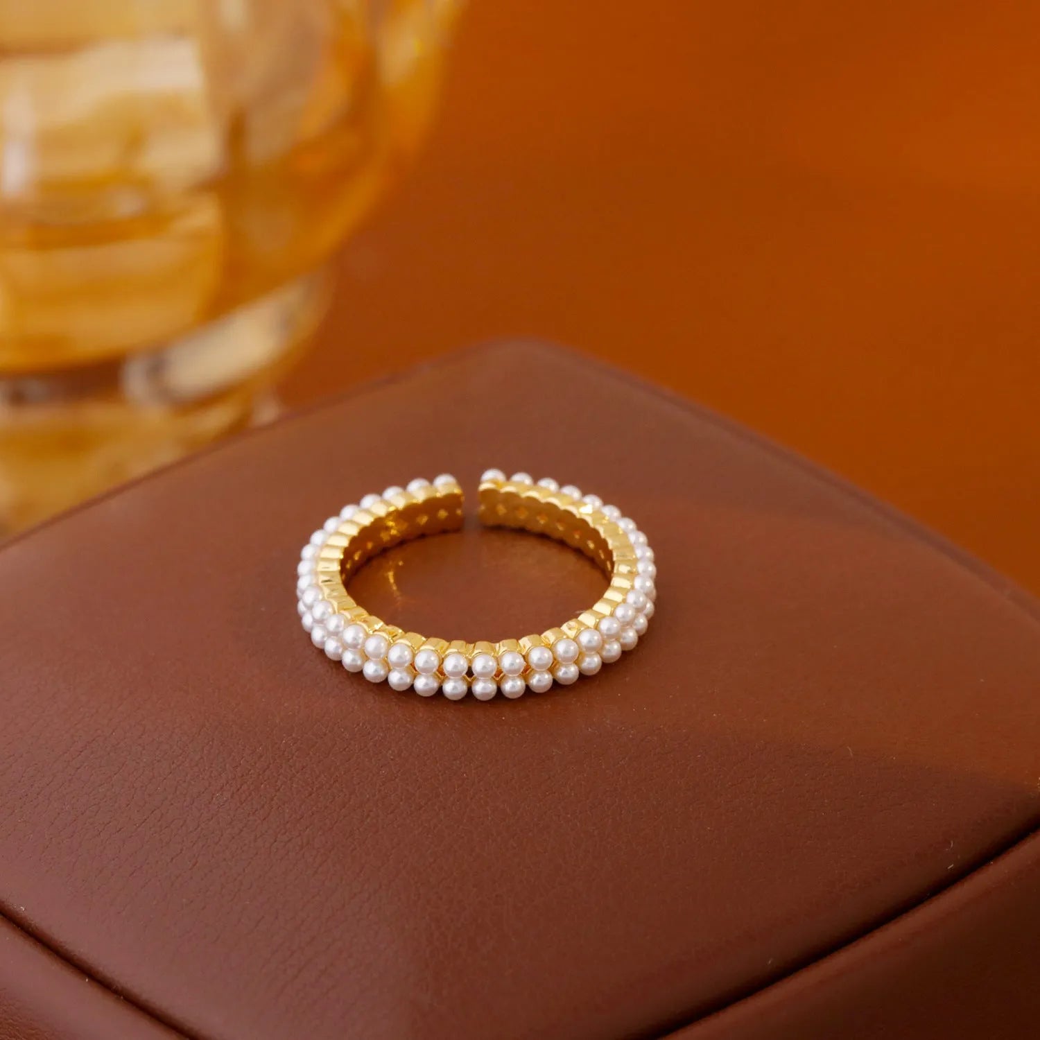 Gold-coloured geometric open-mouth ring with pearl detailing on copper electroplated band