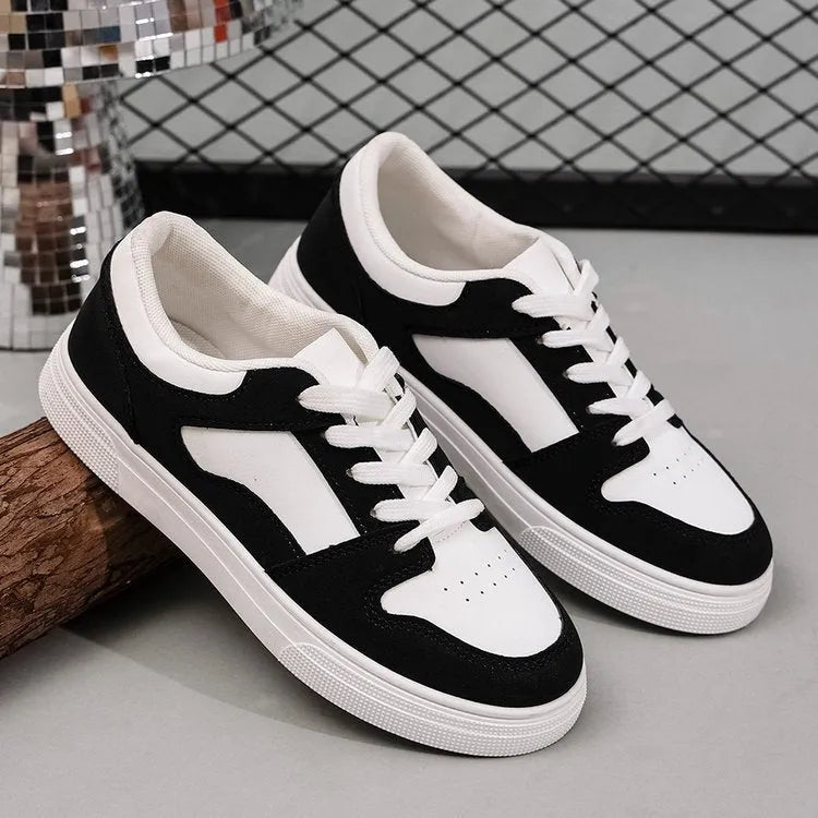 Black women's casual sports shoes with artificial PU upper and rubber sole, showing round toe and lace-up design