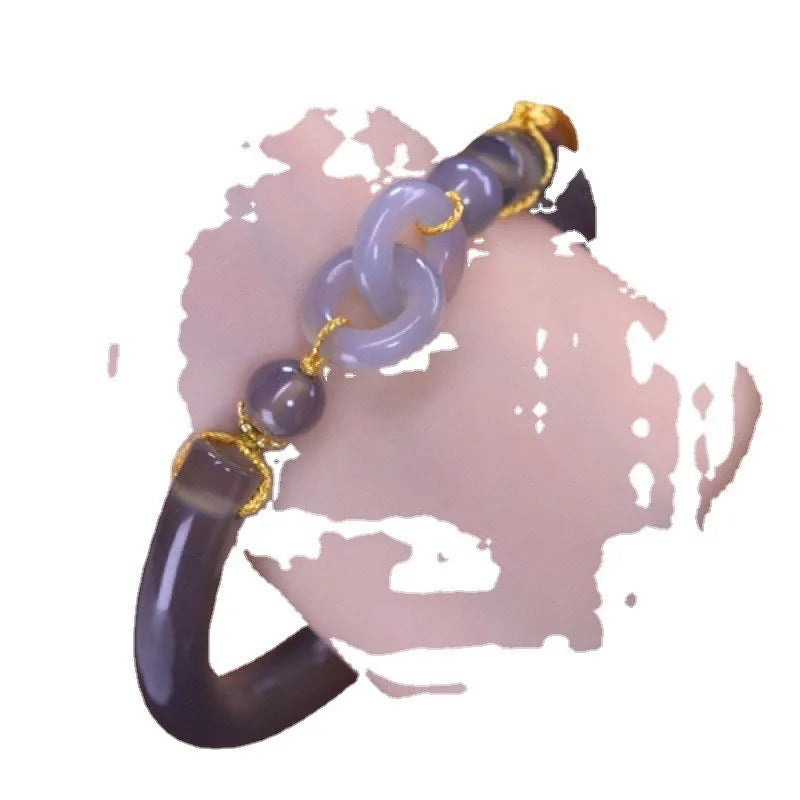 Close-up of a smoke purple grey agate half bracelet with a metal ring buckle closure on a wrist.