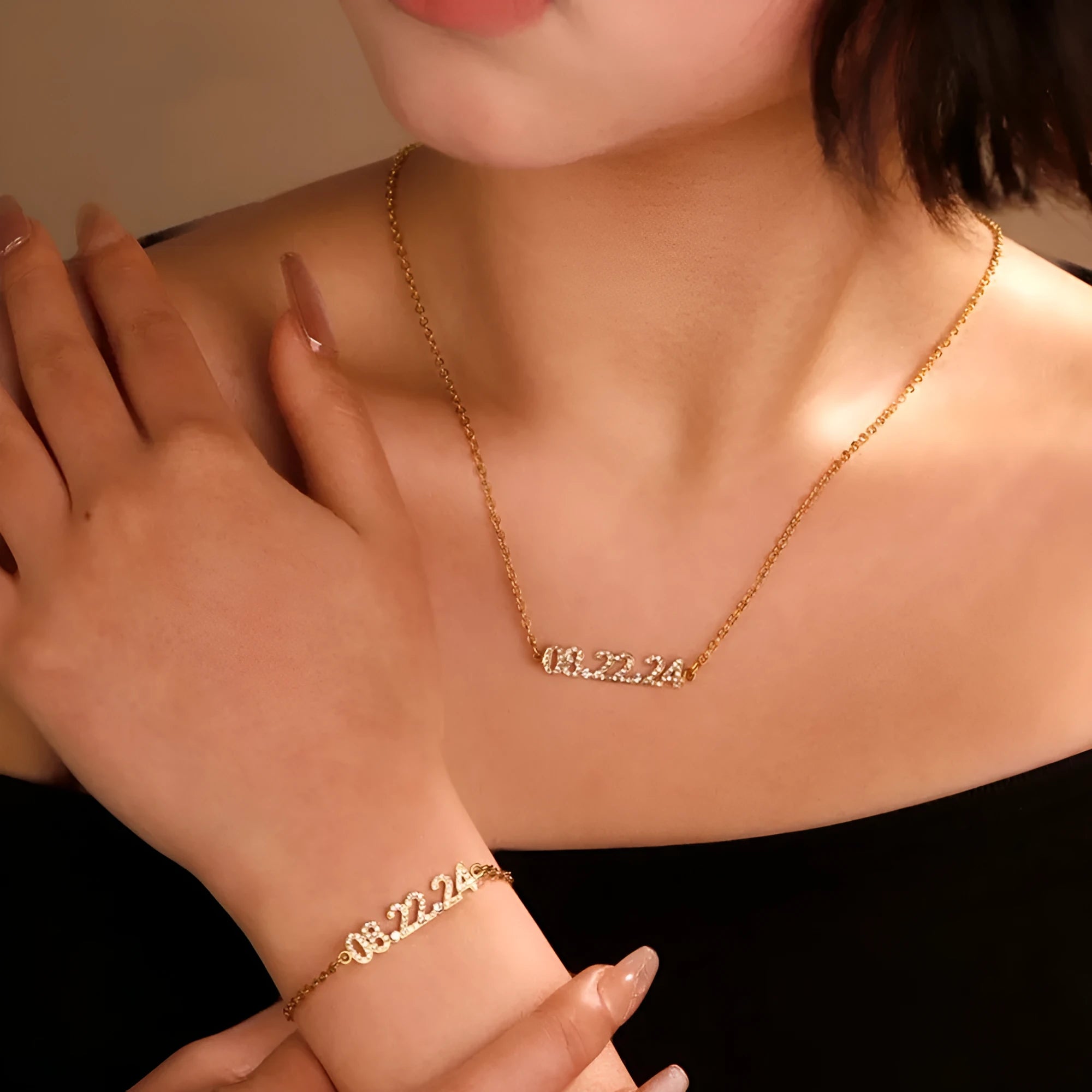 Stainless steel digital bracelet with crystal-set bezel showing time display, alongside matching necklace option.
