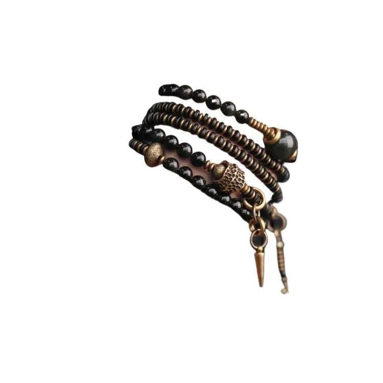 Black multi-layered beaded bracelet with colourful geometric and natural style beads.