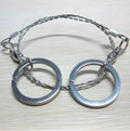 Coiled stainless steel survival wire saw with two black thumb rings, shown next to a ruler showing its 55cm length.