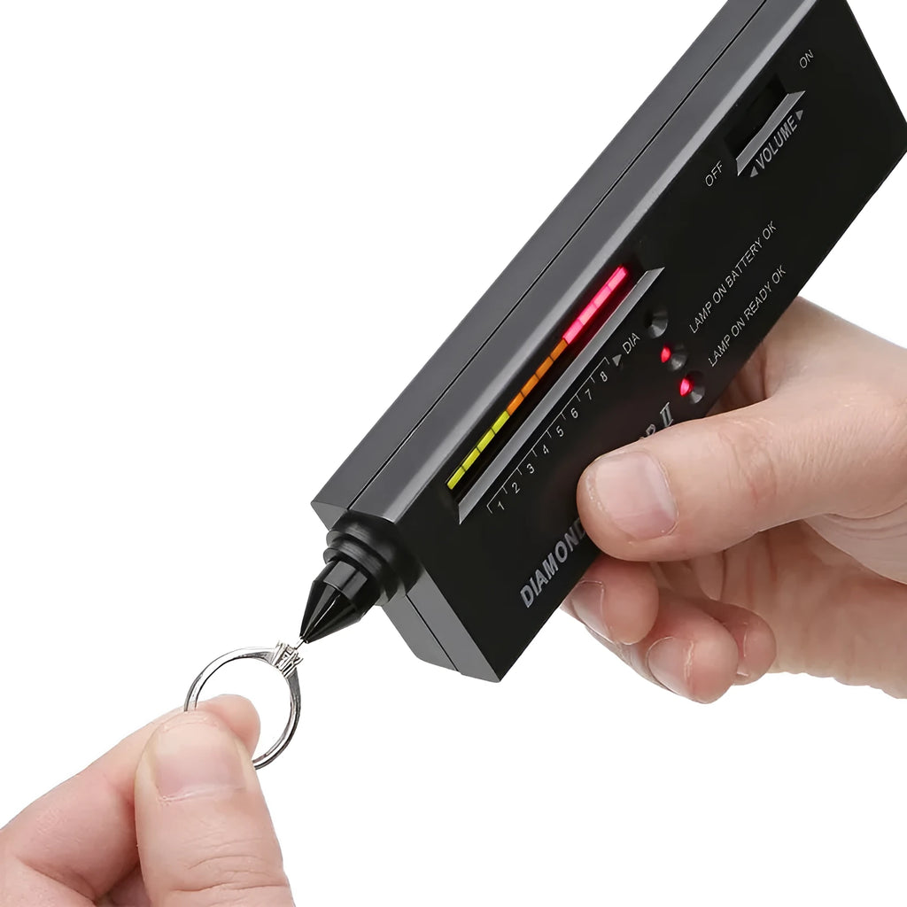 Black handheld diamond thermal conductivity tester with metal probe on a grey background.