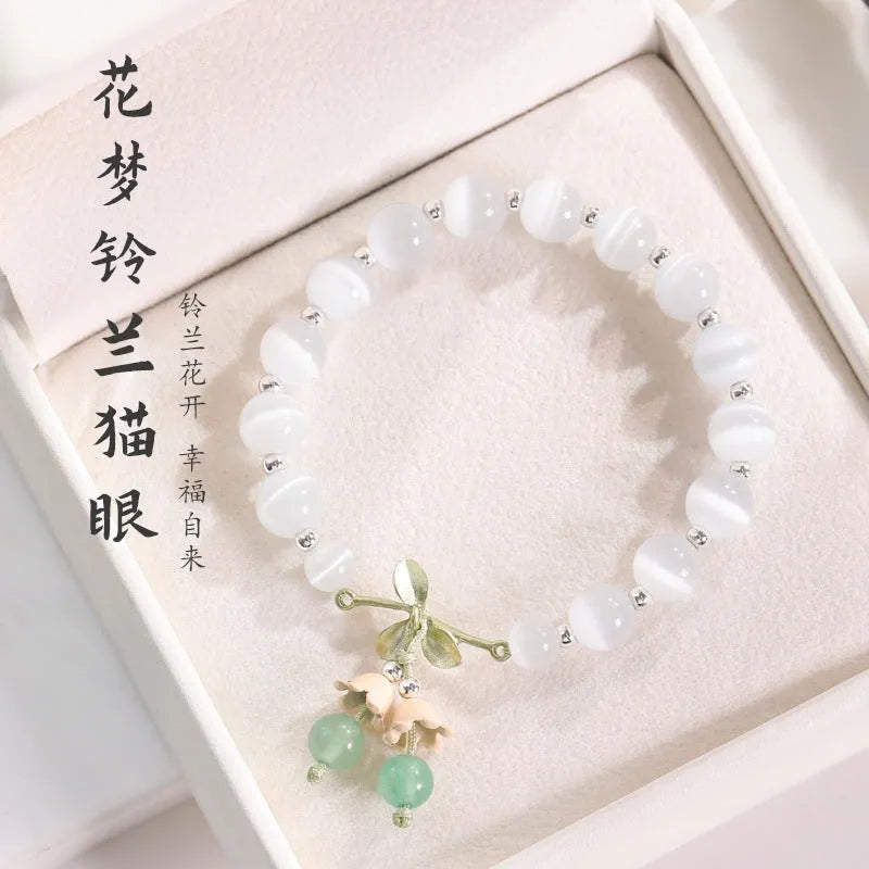 Women's bracelet with multiple diamond-shaped cat's eye opal beads on a string.
