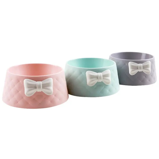 Bow-shaped cat bowl dog bowl in PP plastic, shown in pink, green, and grey.