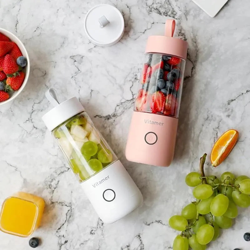 White portable USB rechargeable blender with 350ml cup and silicone handle on a table.