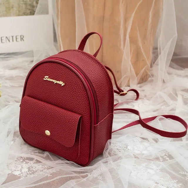 Women's small black backpack purse with adjustable straps showing 18.5cm length and zipper closure
