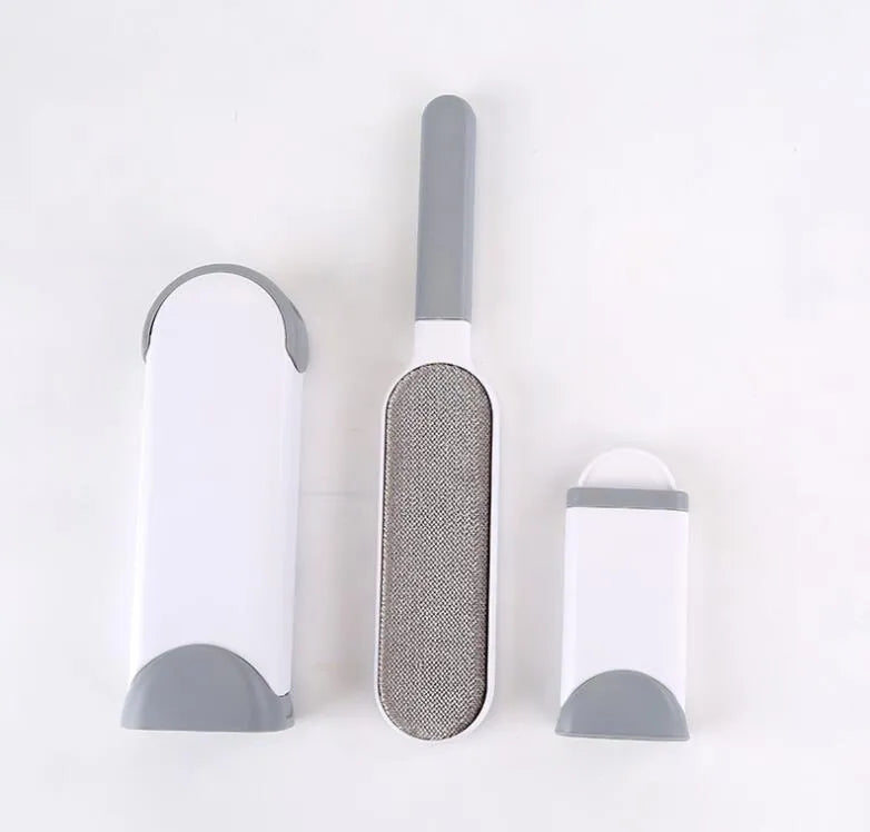 Blue reusable pet hair removal comb with double-sided flannel brush next to its self-cleaning base unit.