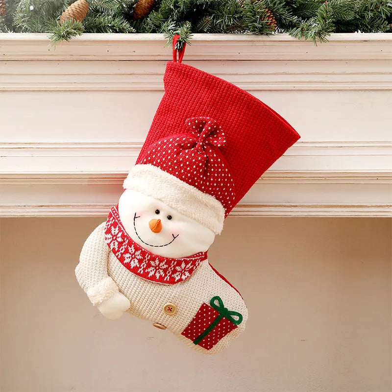 Large red white knitted Christmas stocking with Santa Claus design hanging above fireplace