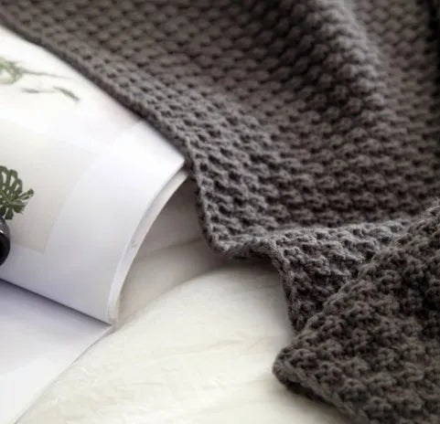 Nordic style acrylic knit blanket with ball fringe, shown in beige, dimensions 130 by 170 cm.