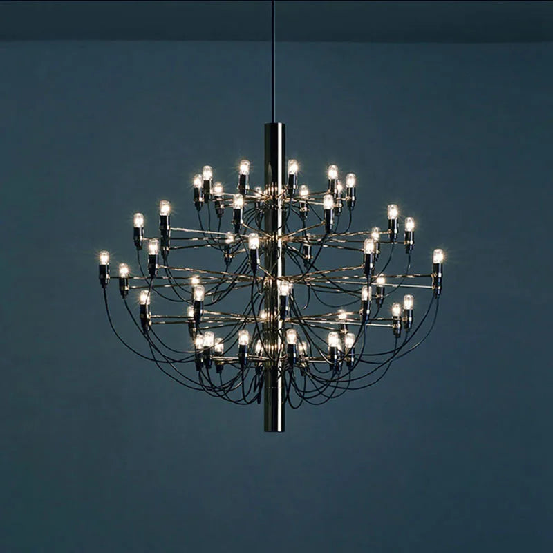 Modern three fork floor lamp with wood body and white acrylic shade on a wooden floor.