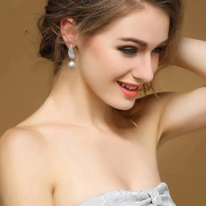 Platinum colour angel wing silver earrings with diamond treatment and gold-plated gemstone inlays