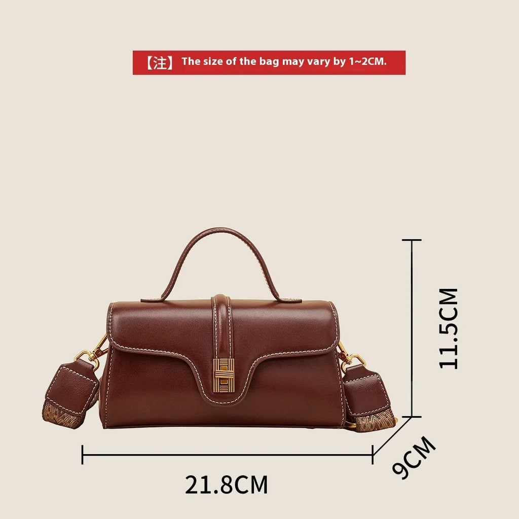 Brown Cambridge-style leather messenger bag with a front lock, shown open to reveal internal zipper pockets.