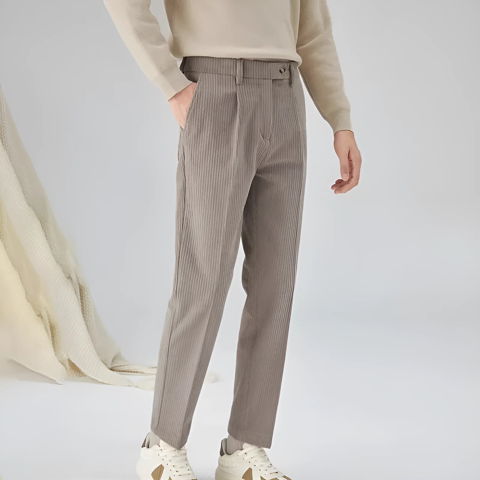 Men's beige straight-leg corduroy trousers with a mid waist and micro elasticity, laid flat.