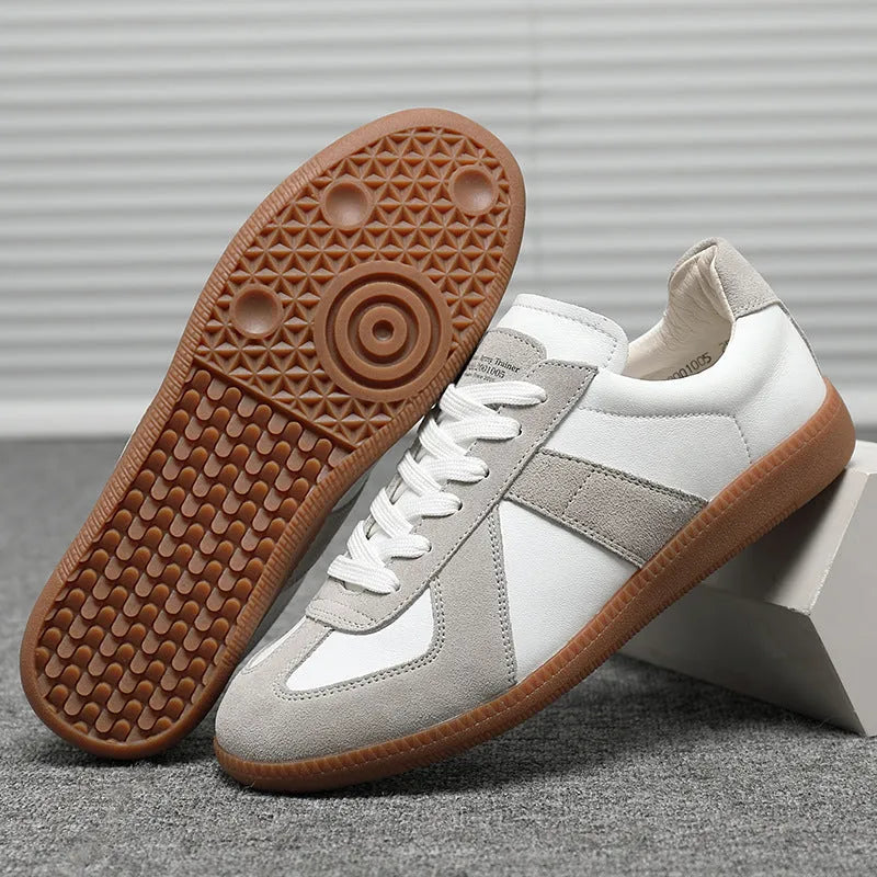 White Japanese-style retro unisex board shoes with lace-up front and round toe on a rubber sole.