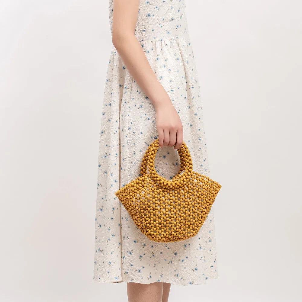 Hand-woven maple wood beach bag with wooden beads in dumpling shape.