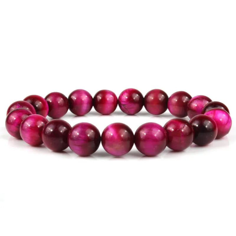 Natural tiger eye crystal bracelet with round beads in dark blue colour, showing tiger eye banding patterns