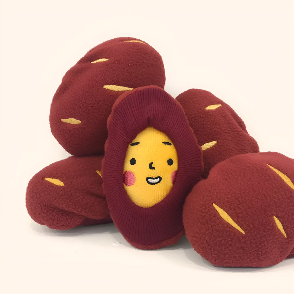 Sweet potato pet puzzle toy with removable peel showing internal food pockets for hiding treats