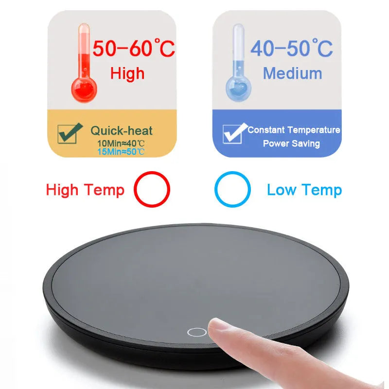 Black coffee cup warmer pad with temperature switch on a desk next to a mug.
