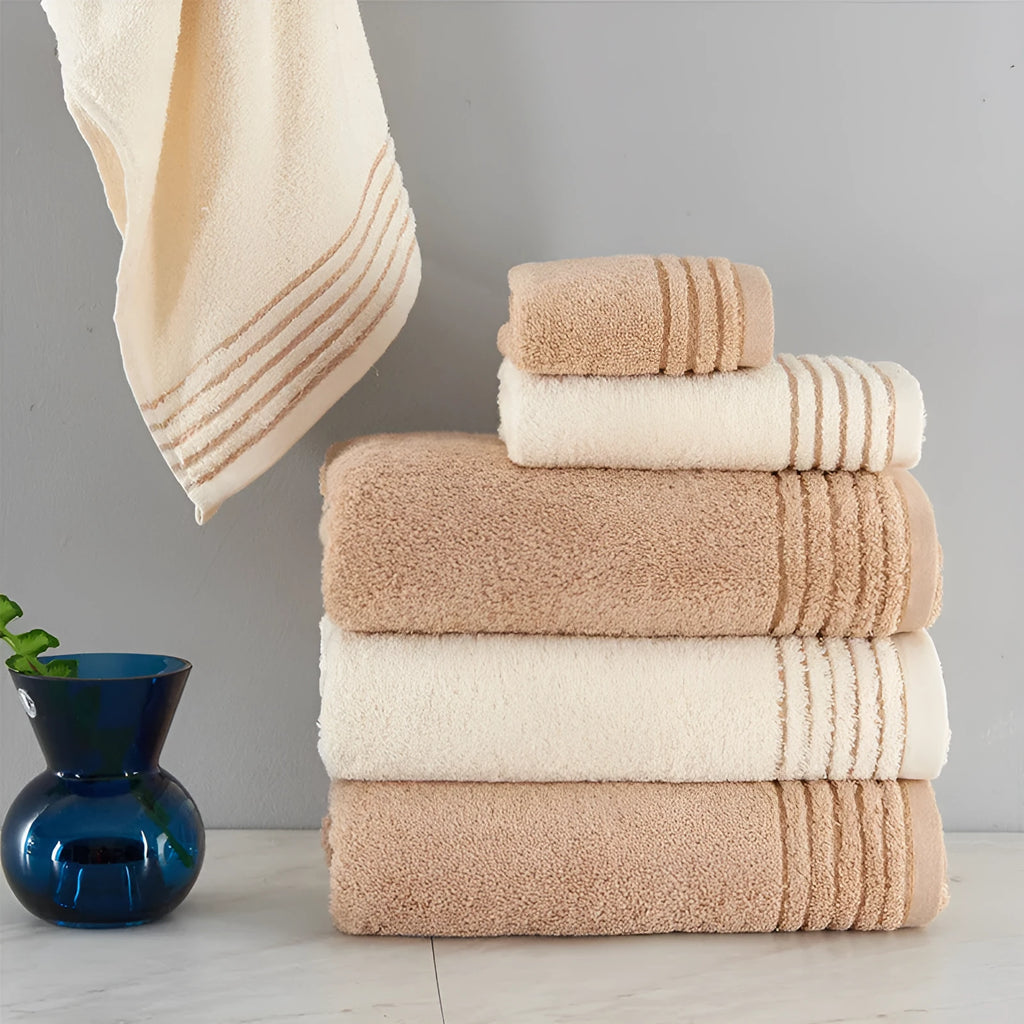 Cotton towel set in brown showing three sizes: large bath sheet, standard bath towel and small hand towel