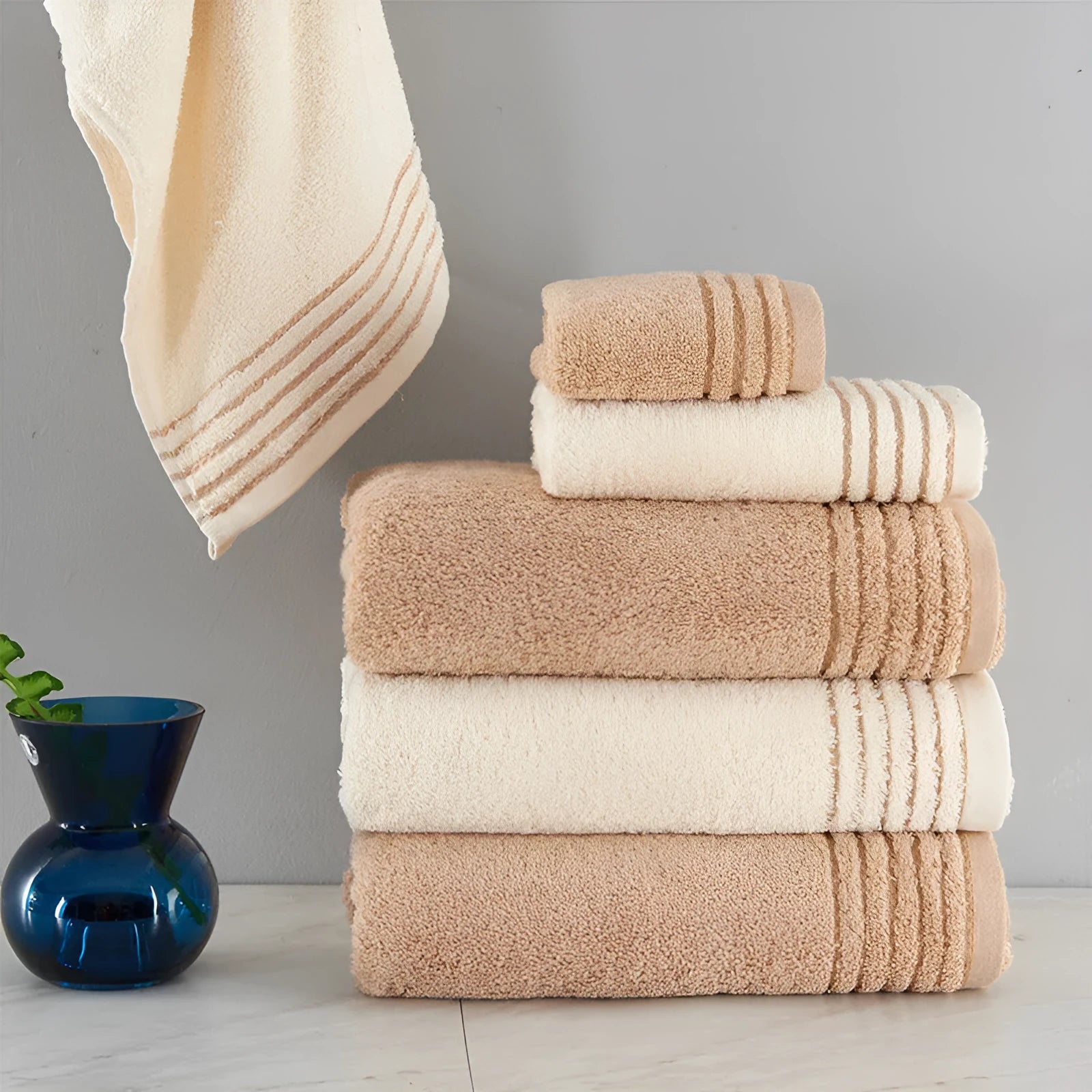 Cotton towel set in brown showing three sizes: large bath sheet, standard bath towel and small hand towel