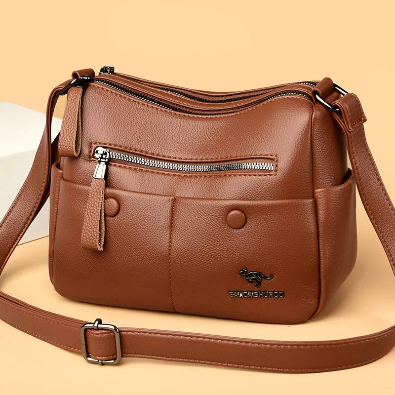 Women's soft leather crossbody bag in horizontal square shape with stitching details and crossbody strap