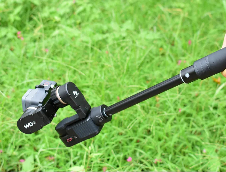 Black retractable selfie stick extended to full 100cm length with phone attached and Bluetooth remote control