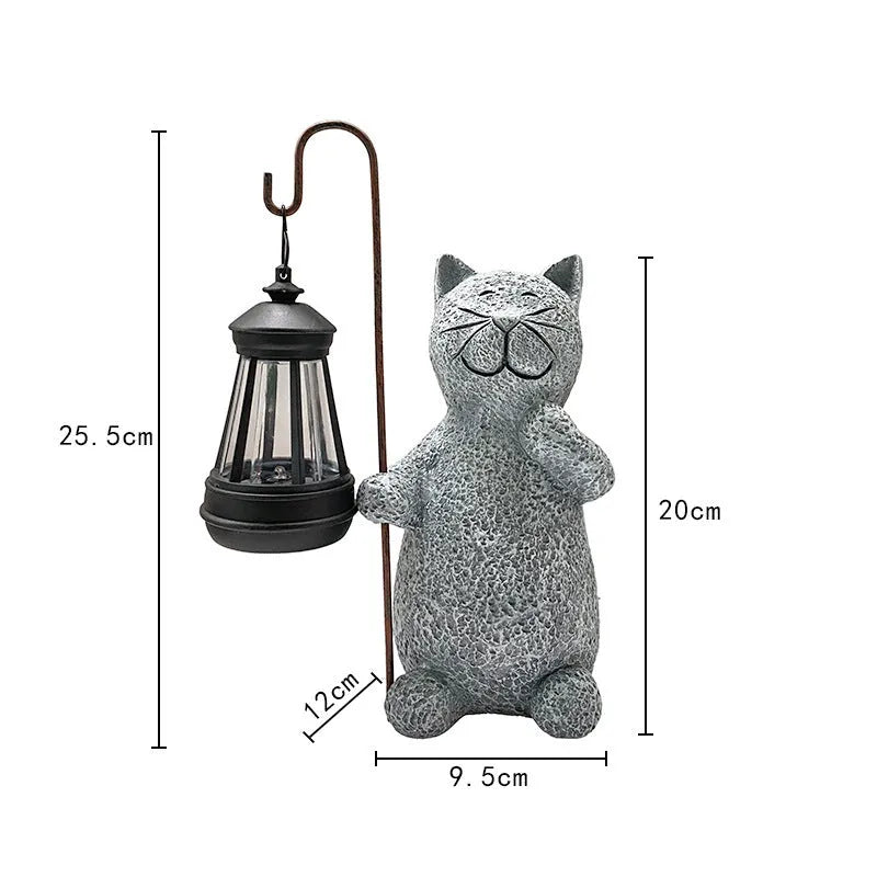 Solar garden light featuring a resin sculpture of a kitten holding up a lantern.