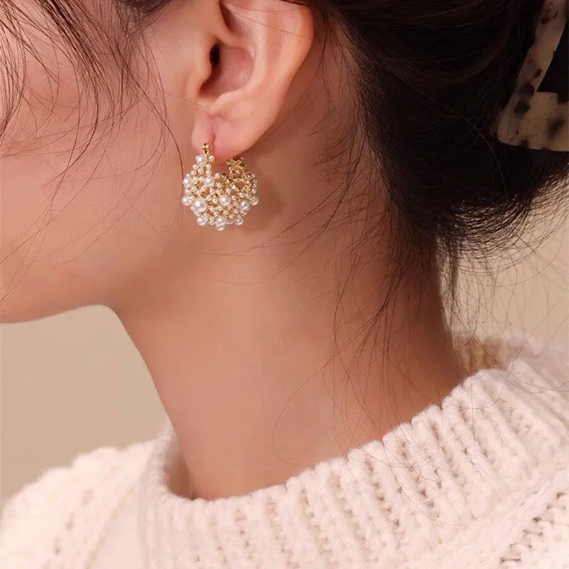 Women's copper flower basket earrings with small rice-shaped beads in gold finish, approximately 3-4 cm diameter