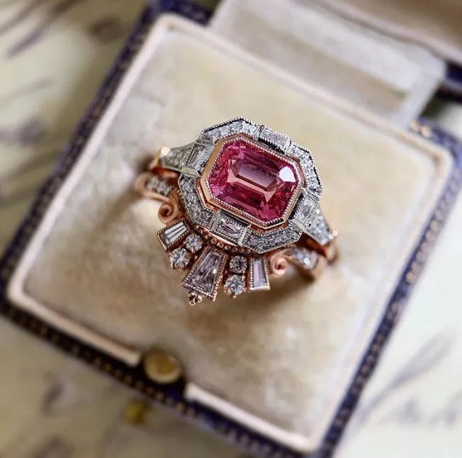 Rose gold alloy women's ring with geometric design and ruby accent, available in sizes 5 to 11.