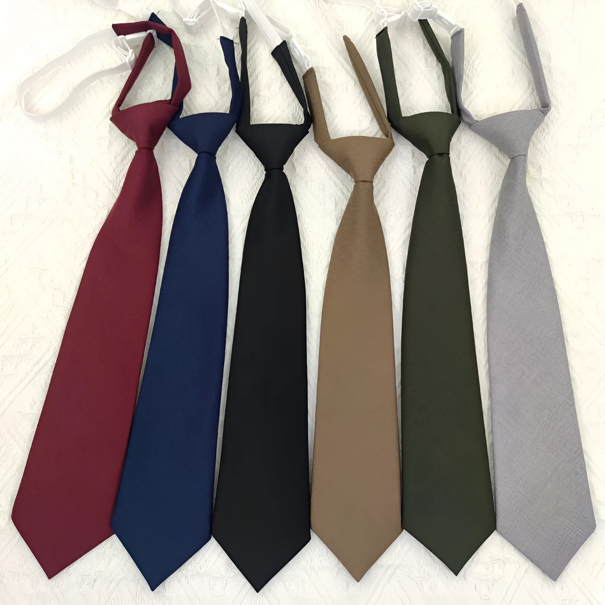 Navy blue solid colour cotton men's tie with arrow style design on a white background.
