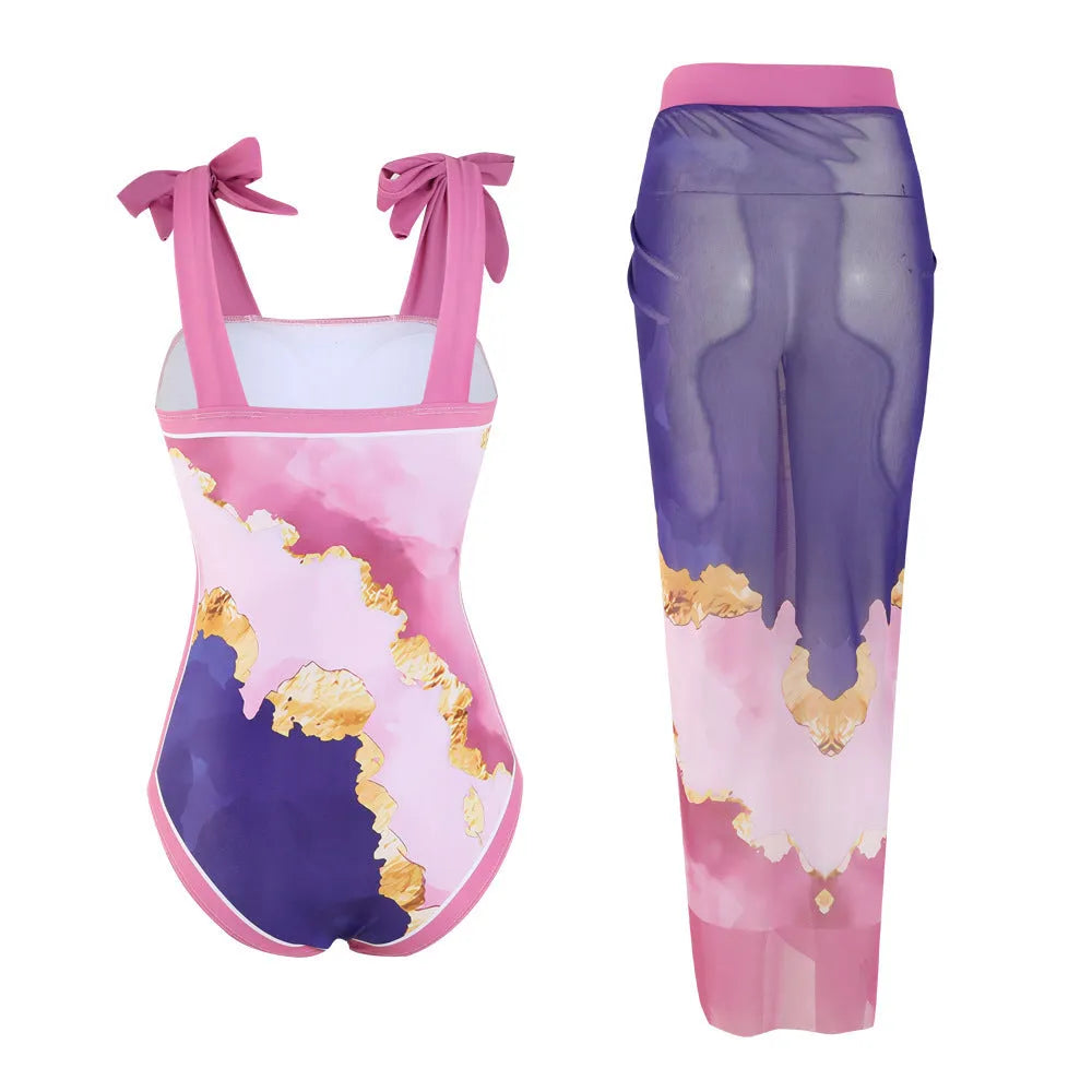 Floral print one-piece swimsuit with mesh tube top and a matching detachable skirt laid flat.