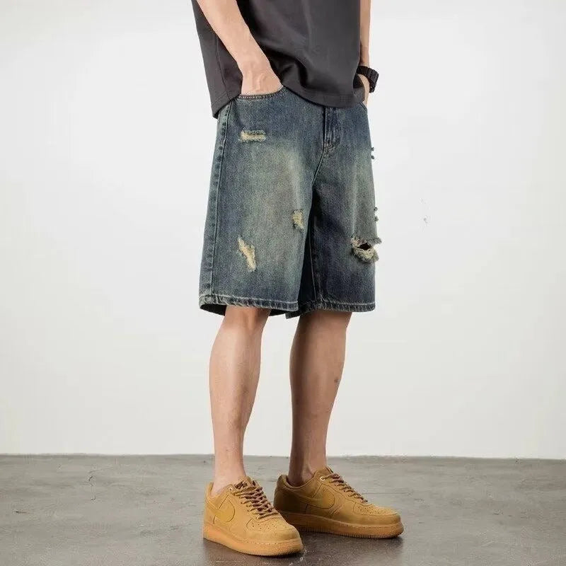 Blue retro-style men's denim shorts with a straight leg and slight distressing details on a neutral background.