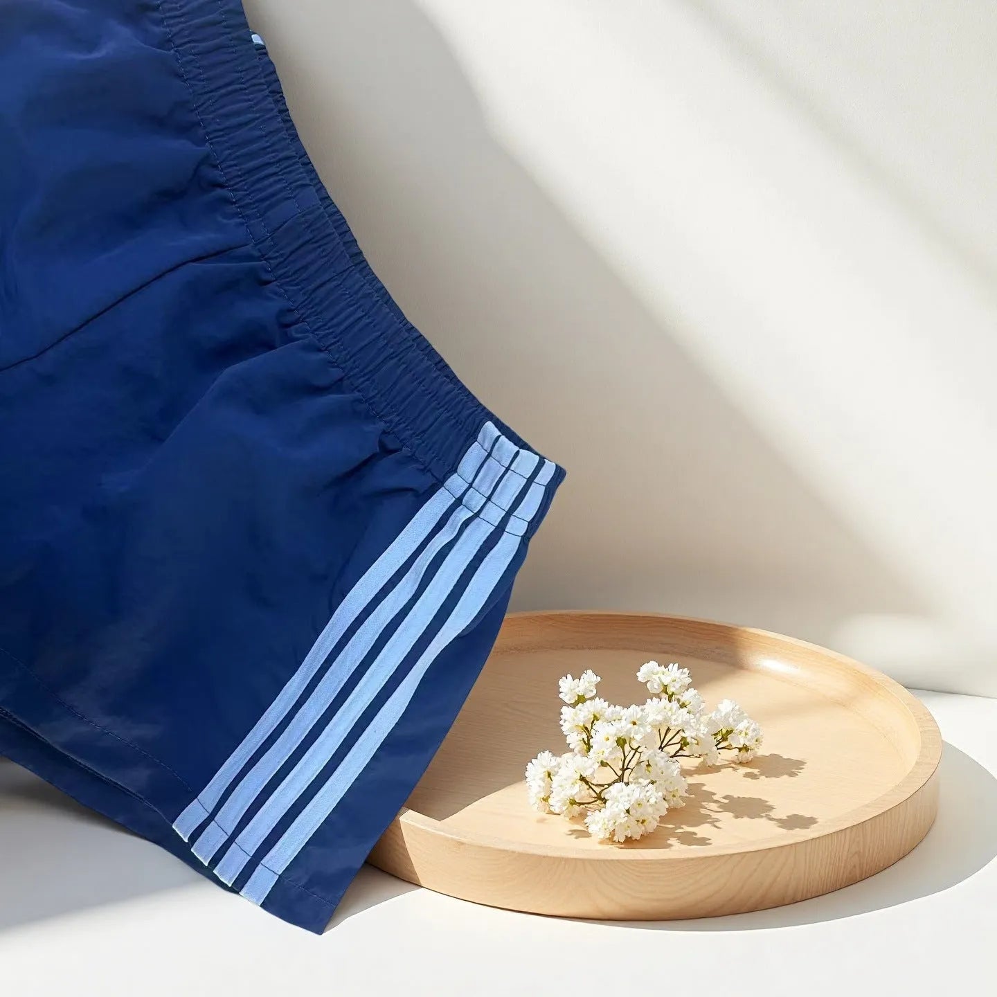 Navy blue men's high-waist nylon sports shorts on a white background