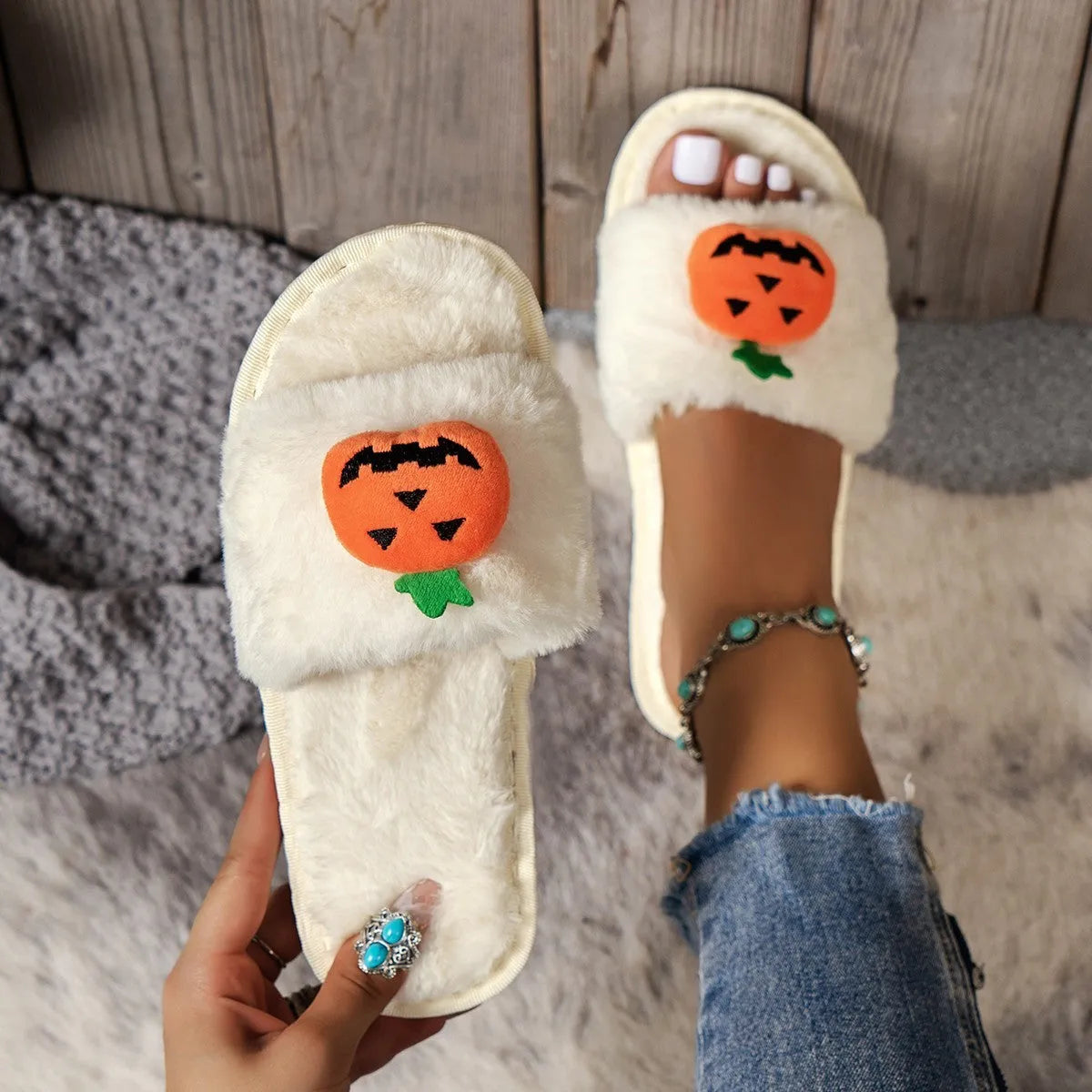 Halloween pumpkin plush slippers with open toe design showing synthetic fur uppers and PVC soles