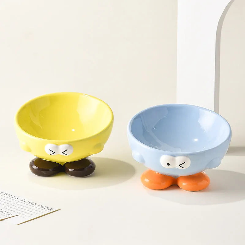 Blue slanted ceramic pet bowl for cats and dogs on a plain background.