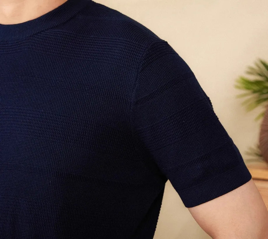 Pure cotton short sleeve T-shirt in off-white with a round neck, laid flat