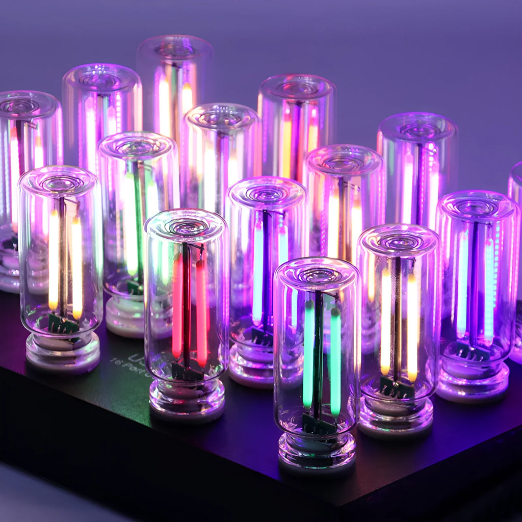 Small transparent glass USB touch night lamp with platinum base on a surface, showing warm white glow.
