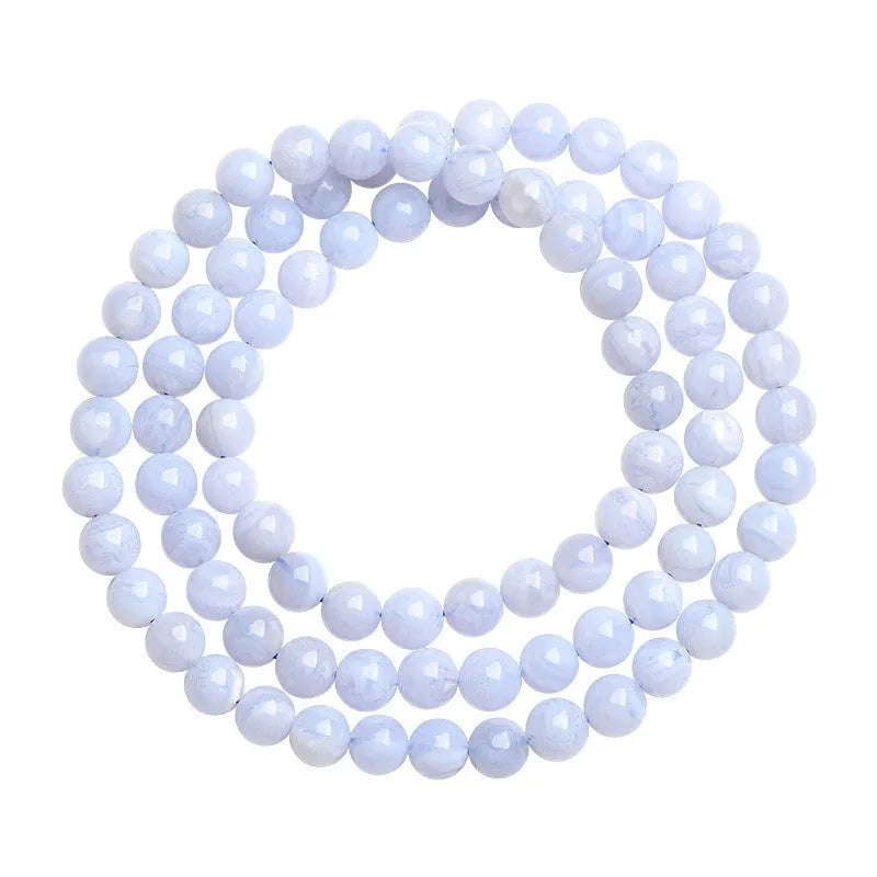 Blue agate bracelet with 6-6.8mm beads showing multi-circle pattern and scattered striped agate beads, Ruyi elements visible