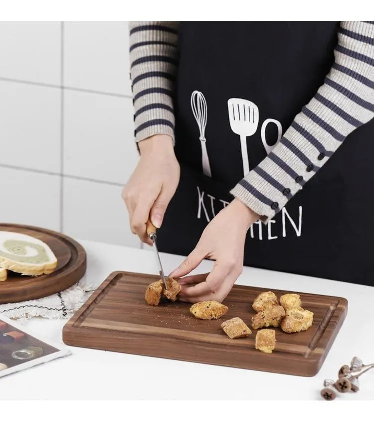 Black walnut wood cutting board with sauce groove and side handle in round and rectangular sizes