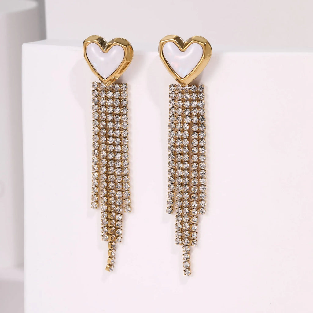 Gold-colour stainless steel earrings with heart and star tassel designs on a white background.