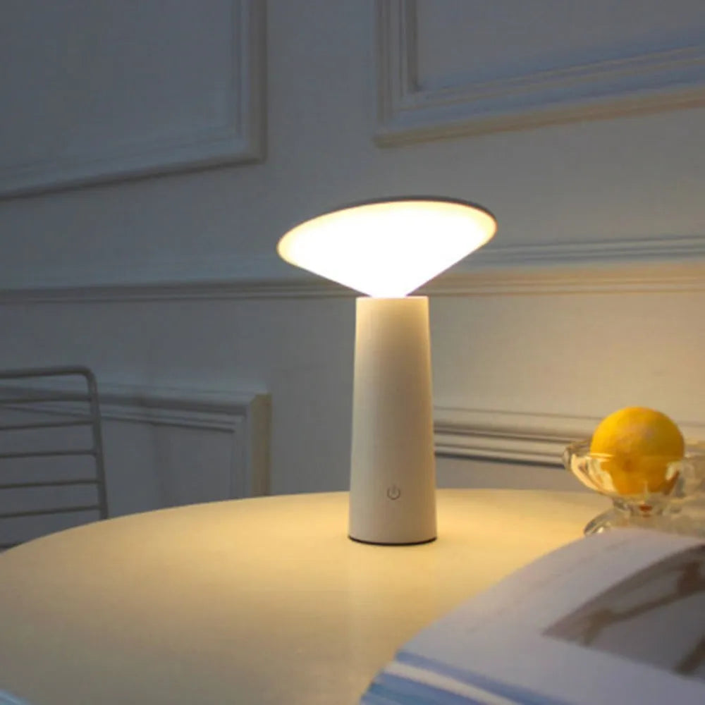Black USB desk lamp with touch sensor and adjustable head on a wooden table