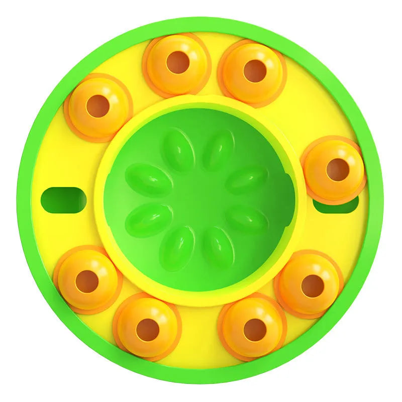 Square green interactive dog puzzle feeder bowl with central column and top turntable on a non-slip base.