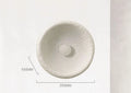 Japanese-style simple white resin wall lamp emitting warm light on a plain wall.